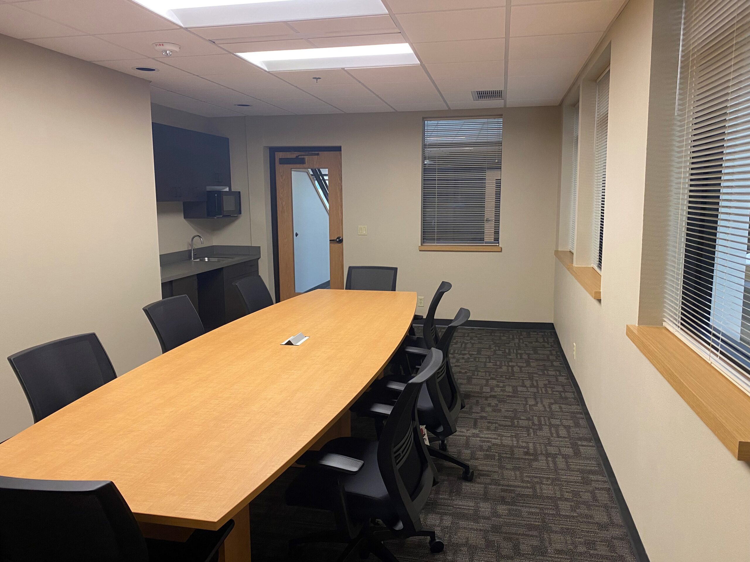 conference room with table and windows to lobby